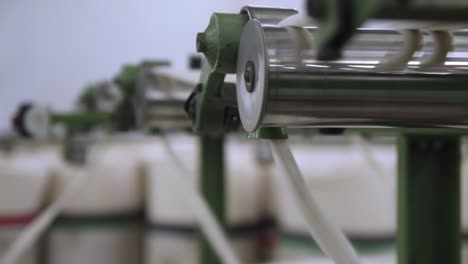 Closeup-Shot-Of-Cotton-Spinning-In-A-Textile-Production-Mill