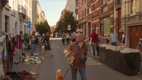 People-Walking-In-The-Street-With-Second-hand-Trade-Market-In-Brussels,-Belgium