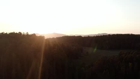 Majestic-Sunrise-Illuminated-Forested-Mountains.-Aerial-Wide-Shot