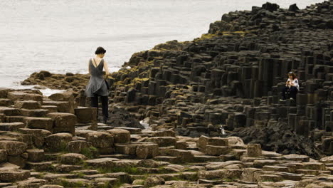 Tourist-At-The-Giant's-Causeway-With-Basalt-Columns-On-The-North-Coast-Of-Northern-Ireland