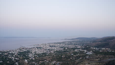 Misty-aerial-descent-over-island-coastal-port-city-of-Chios,-Greece