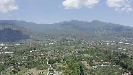 Rural-flyover-of-olive-grove-fields-outside-a-Greek-mountain-village