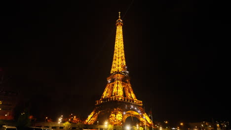 Landscape-view-of-the-shiny-Tour-Eiffel-from-a-boat-on-the-Seine-river-in-Paris,-at-night,-France