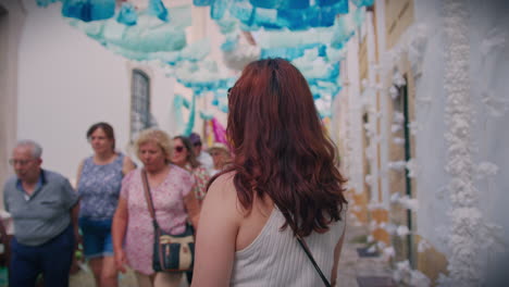 girl-at-festa-dos-tabuleiros-tomar-portugal-in-decorated-street-smilling-into-the-camera