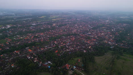 Aerial-birds-eye-shot-Over-small-city-of-Ubud-on-Bali-during-cloudy-day---Tourist-attraction-city-in-Indonesia