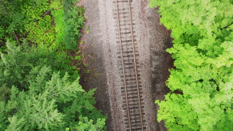 Spiraling-Aerial-View:-Well-Maintained-Railroad-Tracks-Amidst-Lush-Foliage-in-Vermont