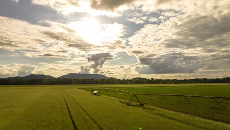 Sunset-over-agricultural-fields-along-commercial-crop-sprinkler,-Dardanelle,-Arkansas,-USA---Hyperlapse
