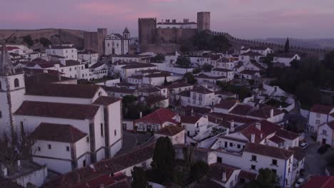 Reveal-shot-of-medieval-town-Obidos-Portugal-during-sunrise