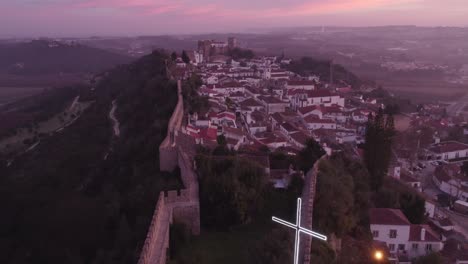 Flying-over-Obidos-Portugal-during-sunrise-with-lot-of-colours,-aerial