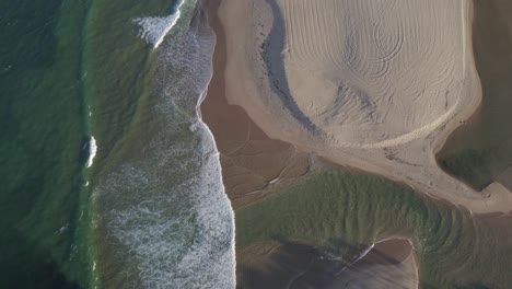 Foamy-Waves-of-the-Ocean-Splashing-on-the-Beach-by-Currimundi-Creek,-Sunshine-Coast,-Queensland,-Australia-Aerial-Shot