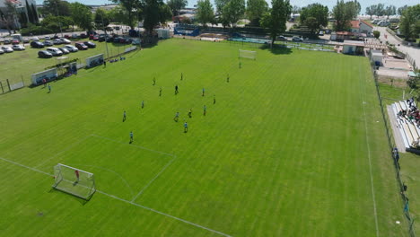 Soccer-Football-Match-In-Baska,-Krk,-Croatia---aerial-pullback