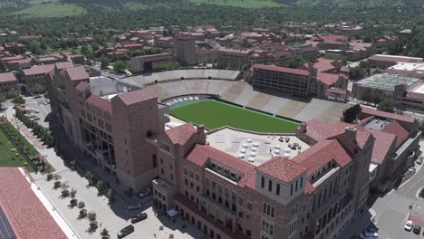 Drone-Shot-of-Folsom-Field-Stadium,-University-of-Colorado-Campus-in-Boulder-USA-on-Sunny-Day,-Revealing-Flatirons-Mountain-Hills