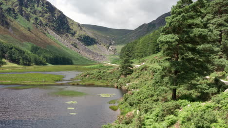 Aerial-Reveal-Shot-of-Glendalough-Upper-Lake-in-Wicklow-Mountains-National-Park