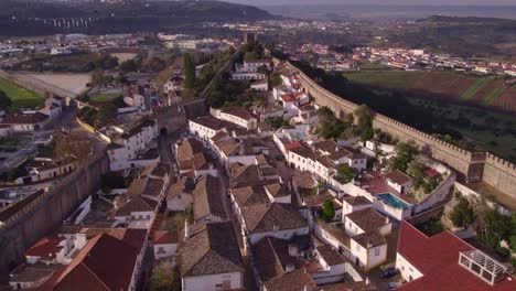 The-main-street-of-Obidos-Portugal-in-the-morning-with-no-people,-aerial