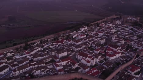 Wide-shot-of-medieval-portuguese-town-Obidos-surrounded-fortress-wall,-aerial
