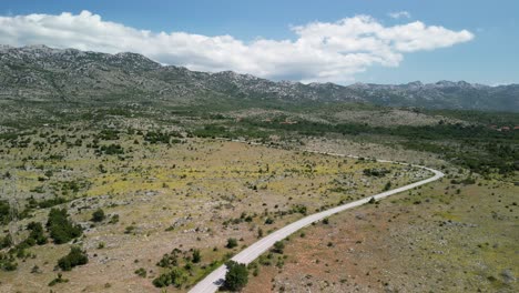 An-aerial-over-lonely-road-in-wast-region-of-Velebit-mountain-in-Zadarska-county,-Croatia