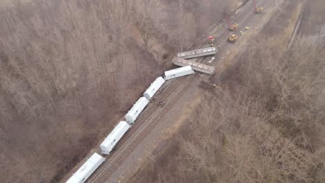 People-working-on-train-derailment-in-Michigan,-aerial-drone-view