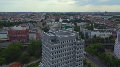 Unbelievable-aerial-top-view-flight-Ghetto-Building-Mehringplatz-place-city-Berlin-steglitz,-Germany-Summer-day-2023