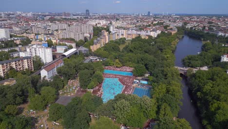 Great-aerial-top-view-flight-overcrowded-public-swimming-pool-Prinzenbad,-city-Berlin-Germany-Summer-day-2023