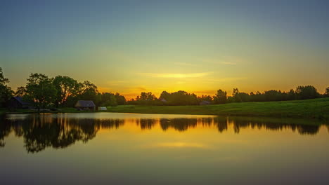 Dawn-to-sunrise-Timelapse-above-calm-cabin-on-country-rural-lake
