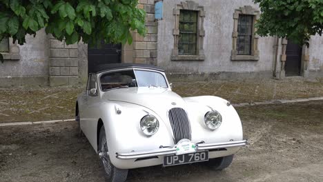 Classic-Jaguar-XK-120-on-display-in-a-courtyard-on-a-classic-car-rally-in-Waterford-Ireland-early-spring-morning