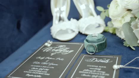 Wedding-invite,-shoes,-bouquet,-and-wedding-ring