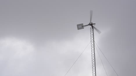 Residential-wind-turbine-system-spinning-on-a-cloudy-day