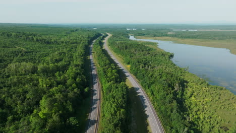 Drone-Soars-High-Near-Presque-Isle,-Showcasing-a-Stunning-View-of-I-95-Highway-in-Maine