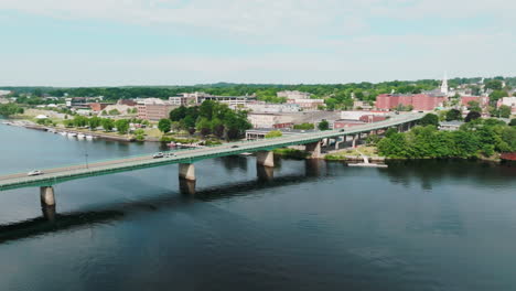 Aerial-Pan-Captures-the-Bustle-of-Traffic-Crossing-the-Bridge-in-Bangor,-Maine