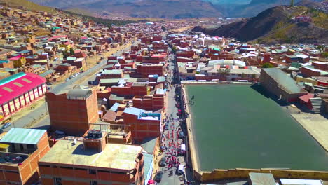 Aerial-drone-view-of-people-celebrating-the-carnival-in-the-streets-of-Potosi,-Bolivia