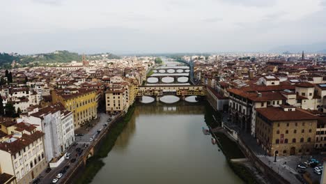 Aerial-view-over-the-Arno-River-in-Florence-Italy-on-a-cloudy-day