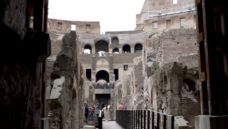 A-breathtaking-establishing-view-of-the-walls-and-arches-of-the-underground-tunnels-of-the-Colosseum-in-Ancient-Rome,-A-popular-tourist-attraction-in-Italy