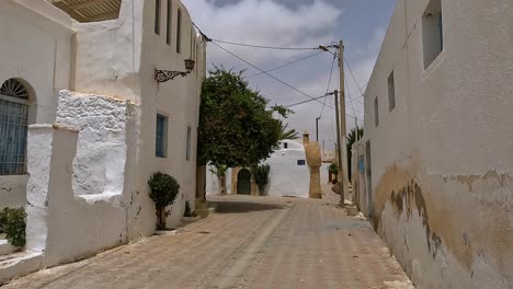 First-person-walking-streets-of-colorful-artistic-Djerbahood-of-Djerba-in-Tunisia