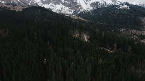 Tilting-drone-shot-pushing-towards-Dolomites-mountains-in-Italy