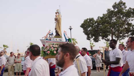 Fishermen-with-the-paso-in-the-procession-with-the-Virgen-del-Carmen-in-the-port-of-Villajoyosa,-Alicante,-Spain,-2023