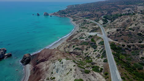 Aerial-drone-follow-shot-along-a-coastal-highway-in-the-Mediterranean-sea