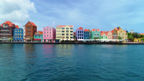 4k-sideways-dolly-along-the-famous-colorful-UNESCO-buildings-of-the-Handelskade,-in-Punda,-Curacao