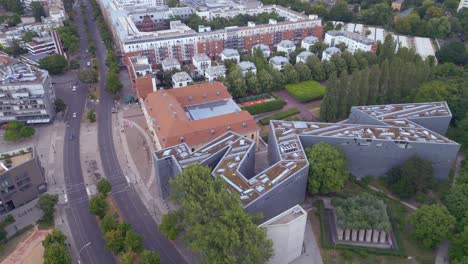 Magic-aerial-top-view-flight-Jewish-Museum-city-Berlin-Libeskind-Building,-Germany-Summer-day-2023
