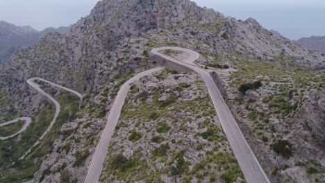 Car-diving-at-famous-mountain-pass-Coll-dels-Reis-Mallorca,-aerial
