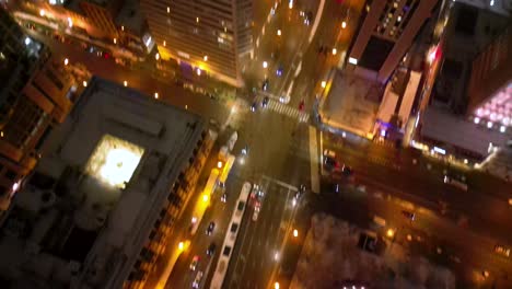 Chicago-USA,-Aerial-View-of-Crain-Communications-Building-at-Night-and-Traffic-on-North-Michigan-Avenue,-Tilt-Down-and-Up-Drone-Shot