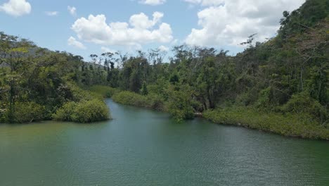 Aerial-view-following-the-Río-San-Juan-river,-in-middle-of-jungle,-in-Samana,-DR