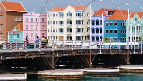 4K-60fps-Filmischer-Langsamer-Parallaxen-Dollyschwenk-Der-Ikonischen,-Farbenfrohen-UNESCO-Weltkulturerbegebäude-In-Willemstad-Und-Der-Schwimmenden-Königin-Emma-Brücke-In-Willemstad,-Curaçao