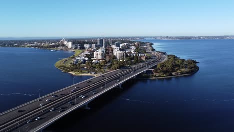 Drone-Aerial-View-of-Freeway-on-Narrows-Bridge-travelling-to-South-Perth-peninsula-and-foreshore-with-Swan-River