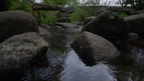 Brücke-Mit-Fluss-Unten,-Während-Die-Kamera-Langsam-Nach-Oben-Kippt,-Im-Nationalpark-Dartmoor,-England