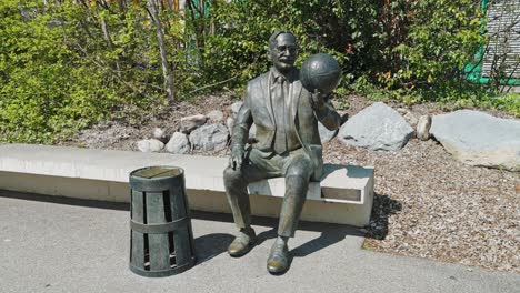 Wide-dolly-of-James-Naismith-statue-holding-a-basketball-at-the-International-Basketball-Federation-Headquarters-in-Switzerland