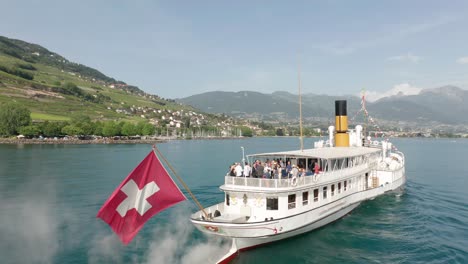 People-standing-on-deck-of-beautiful-old-cruise-ship-on-a-sunny-summer-day-in-Switzerland