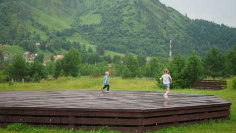 Brother-and-sister-have-fun-together-on-wooden-platform