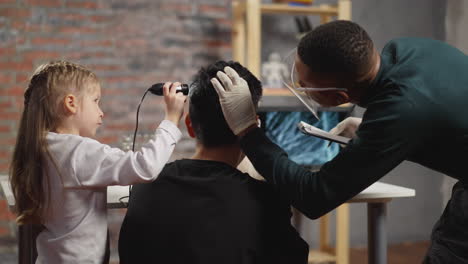 Student-with-biologist-scans-brunet-man-hair-with-probe