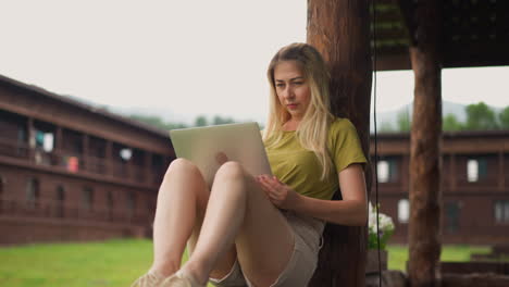 Serious-woman-freelancer-makes-report-on-laptop-in-hotel