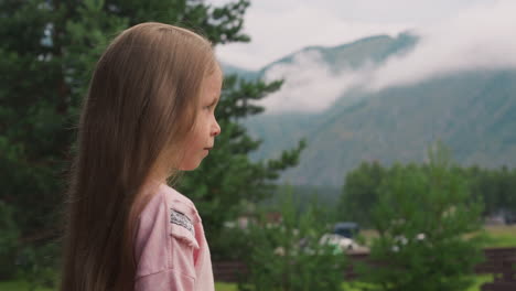 Tranquil-little-girl-with-loose-hair-at-highland-resort